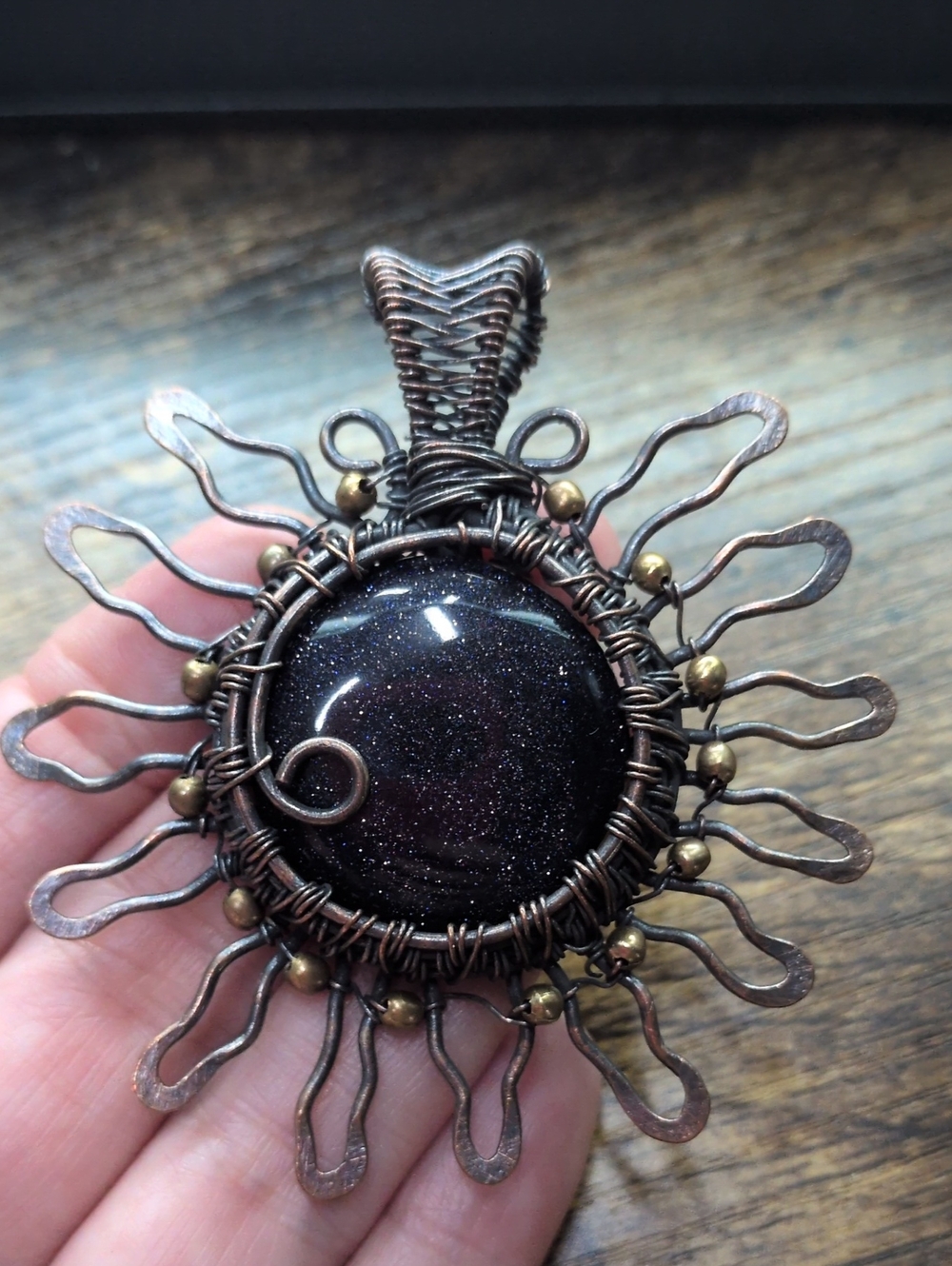Handcrafted Copper Wire Sunburst Pendant with Dark Blue Goldstone